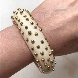 Bone colored bracelet with gold studs